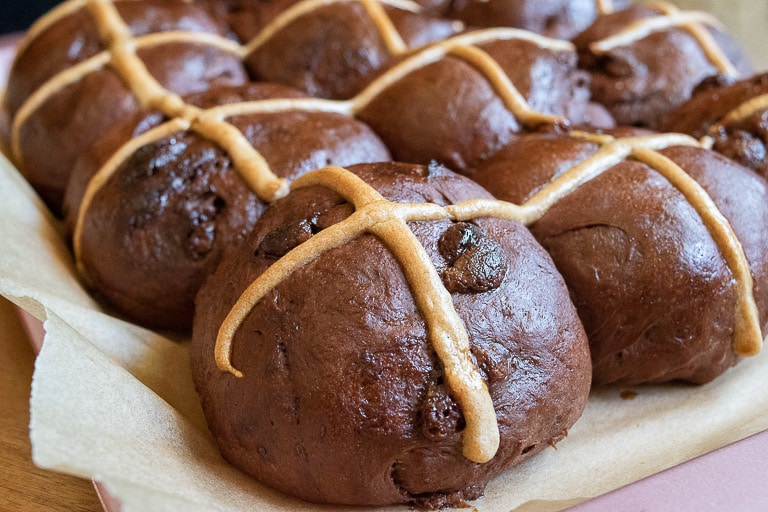 Close up image tray of double chocolate hot cross buns