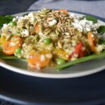 Thermomix risotto on light coloured plate on top of darker larger plate