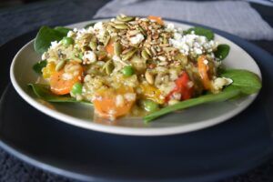 Thermomix risotto on light coloured plate on top of darker larger plate