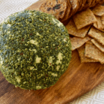 jalapeno cheese ball on board with crackers