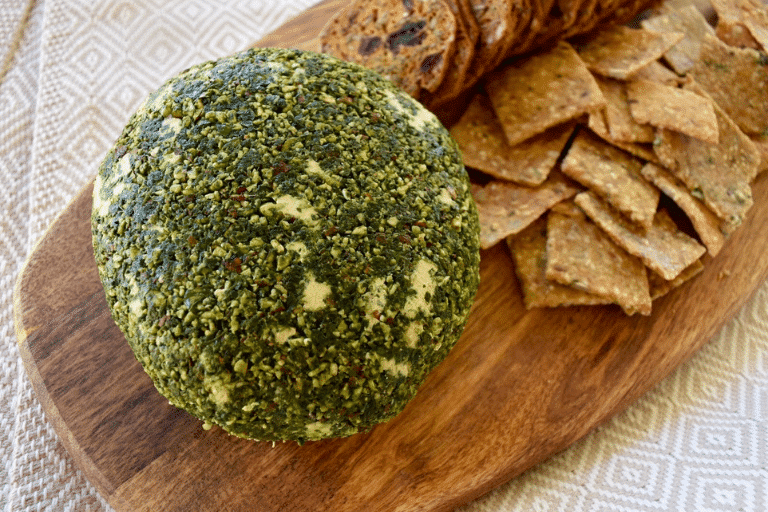 jalapeno cheese ball on board with crackers